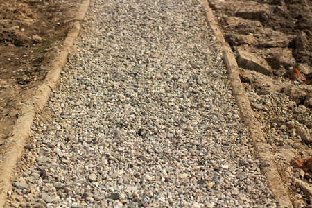 The rubble is on the road. Road repairs. A small stone is like a cushion for asphalt.の写真素材