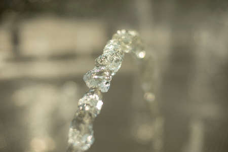 Splashing water. A jet of liquid. Water in natural light. Fountain jet.の写真素材