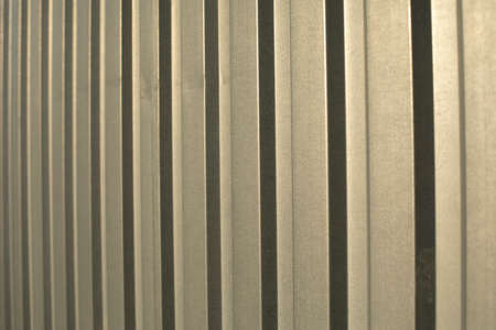 The texture of the metal fence. Stainless steel in sunlight. Simple steel profile background.の写真素材