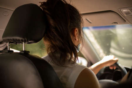 Girl driving a car. Travel by private transport. The woman is driving. The girl is in control.の写真素材