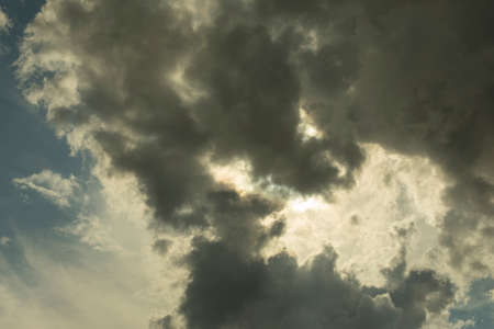 The sun shines through the clouds. Thundercloud. Heavenly landscape on a summer day. Changeable weather.の写真素材