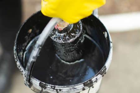 Paint for the street. Painting the object. Marking the road. Work with brush and paint.の写真素材