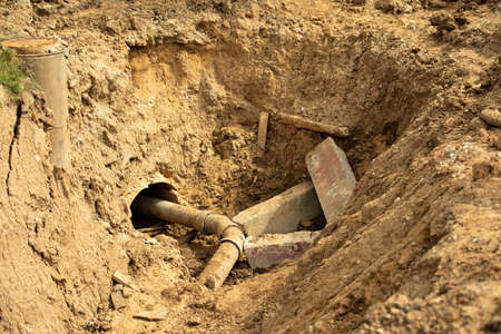 Laying pipes in the ground. The excavated soil during construction. Result of heavy machinery work. The land is prepared for the installation of underground utilities.の写真素材