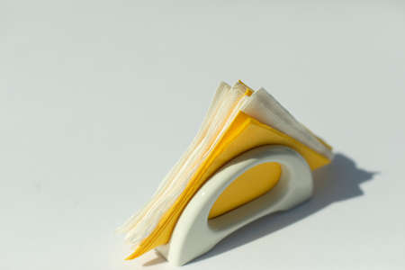 Napkins on a white table. Dinner table setting. Paper napkins in a napkin holder.の写真素材