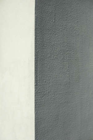 Wall texture. The ratio of white and gray. Shadow on the white wall. Plastered surface. Simple division into two areas of color. Grungy wall texture.の写真素材