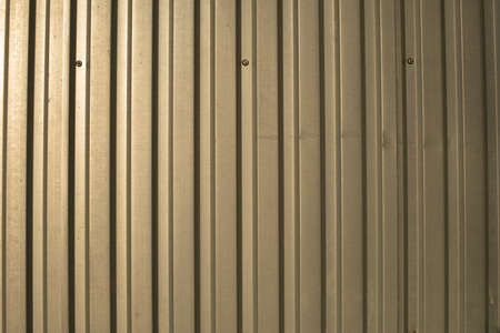 The texture of the metal fence. Stainless steel in sunlight. Simple steel profile background.の写真素材
