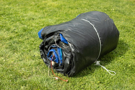 Twisted rubber material. The rain tent is folded. The inflatable structure is ready for transportation and loading.の写真素材