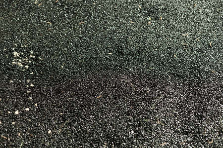 Freshly laid asphalt. Repaired pedestrian road. The black asphalt is still warm.の写真素材
