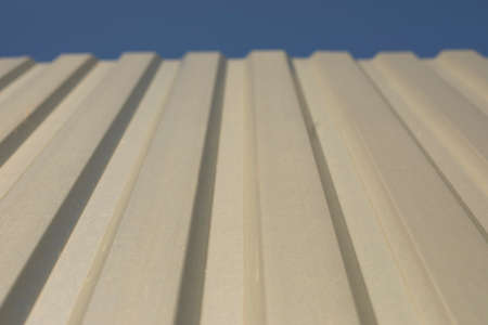Simple fence made of unpainted metal. Stainless steel fence parts. Industrial design of galvanized material.の写真素材