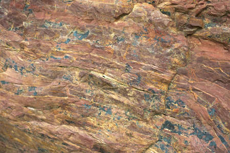 Granite texture. Red stone in detail. Natural background chipping rocks. The stone surface is red brown with inclusions.の写真素材