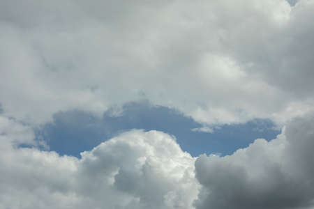 Clouds in the sky. Atmospheric front. Cyclone in the middle lane. White cumulus clouds.の写真素材