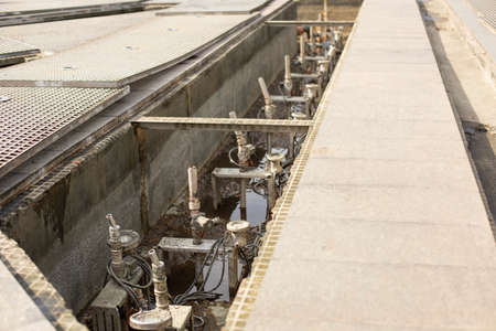 Fountain repair. Disconnected and disassembled fountain. Water communications. Pipes below road level.の写真素材