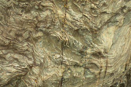 The texture of the stone. The surface of the rock is in detail. Stone background. Chaotic lines in the rock.の写真素材