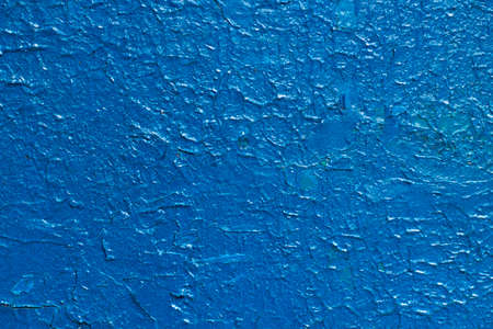 The texture of blue paint. The cracked surface of the wall is painted blue. The background is blue.の写真素材
