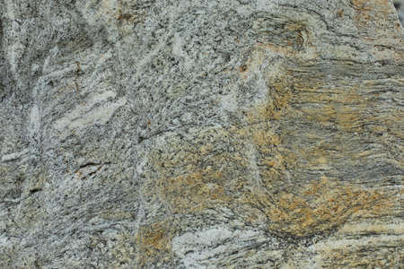 The texture of the rock. The background is a stone surface. Gray stone with rusty inclusions.の写真素材