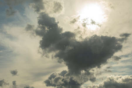 The sun shines through the clouds. Thundercloud. Heavenly landscape on a summer day. Changeable weather.の写真素材