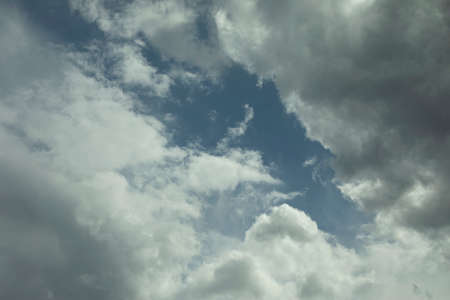 Clouds in the sky. White air masses in the blue sky. Simple background summer weather in the atmosphere.の写真素材