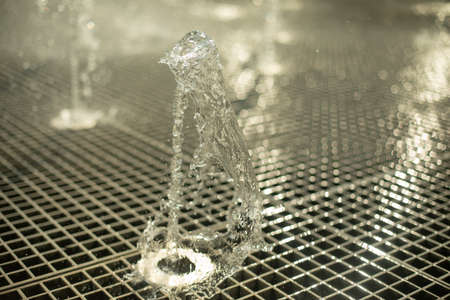 City fountain. Splashes of water on the square. Summer freshness from water jets.の写真素材