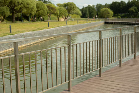 Fence by the water. Steel fence on the bridge. An iron barrier to safety. High fence.の写真素材