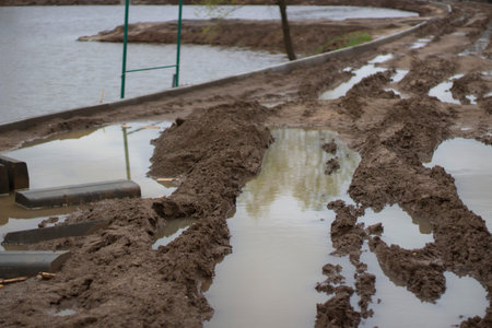 Dirt at a construction site. Dirty road. Off-road after a rainstorm. Puddles and mud.