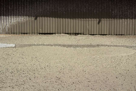 Liquid cement at a construction site. Cement spilled onto the road. The building material is cement and gravel.の写真素材