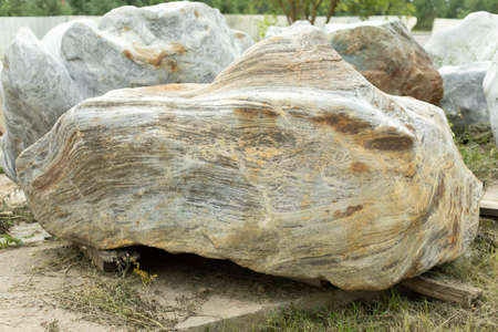 Cobblestones to decorate the park. Stone for the landscape. A huge cobblestone on the street. The rock is prepared for installation in the park.の写真素材