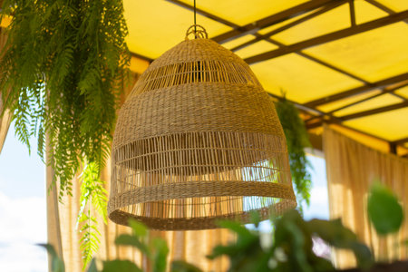 Braided thread lampshade for lamp. Lamp in kafe. The lamp hangs from the ceiling not turned on.の写真素材