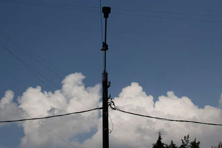 A fan pole against the clouds. A pillar without light. The lights off at the electrical equipment in the city.の写真素材