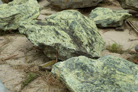 The stone is green. A piece of rock in the park. Rock. Stone for landscape design.の写真素材