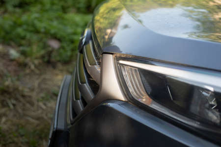 Bumper of the car with front headlight. Hood of transport. A large machine in the details.の写真素材