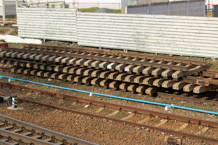 Rails for the railway. Prepared rails on the tracks. The place of unloading sleepers.の写真素材