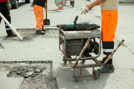 Gasoline generator of electricity. Power supply to the power tool. Generator on the street for road repair.の写真素材