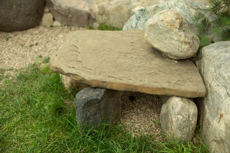 A house made of stones for a turtle in the park. The stones are stacked together on the grass. Landscape decoration with stones of a small yard.の写真素材