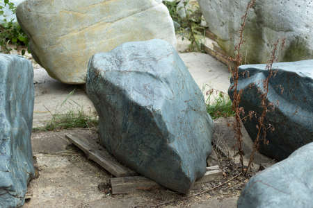 Beautiful stone in the park. A large piece of rock on the street. The cobblestones are prepared for installation in the garden. Sale of stones. Unusual stone.の写真素材