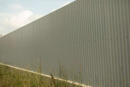 Fence along the territory. Just a fence. An obstacle for a person. Private territory.の写真素材