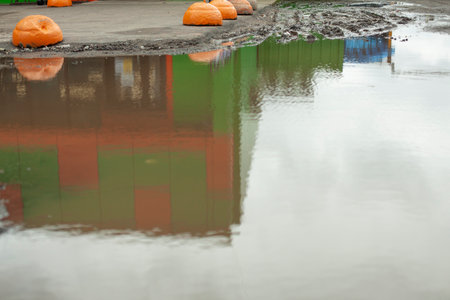 Water accumulates on the road. Flooding of the parking lot. Lots of water outside.の写真素材
