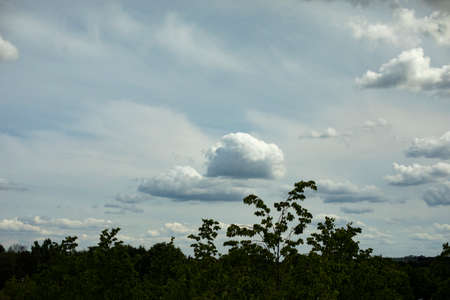 Clouds over the city. Landscape with sky and light clouds. Summer weather.の写真素材