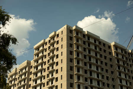 House under construction. Multistorey building. Big construction in the city. Unfinished construction of the house.の写真素材