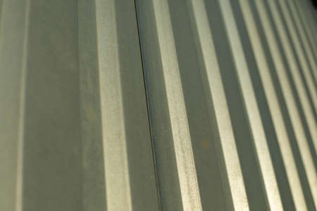 Metal fence in detail. Stainless steel of industrial production. Ribbed surface of the fence.の写真素材