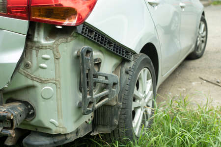 A wrecked car in the back. Damaged car. A broken piece of transport. Removed surface of the machine.の写真素材