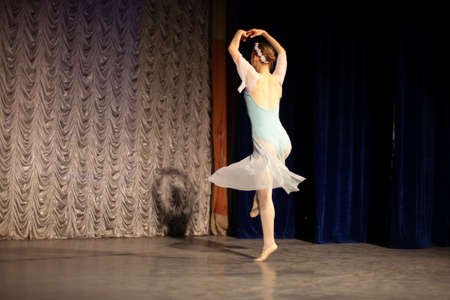 Ballerina on stage. Professional dance. The girl is dancing classical ballet. The graceful movement of a thin girl.の写真素材