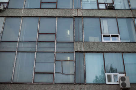 Facade of an air-conditioned office building. Industrial building in the evening. Long building with air conditioning.の写真素材
