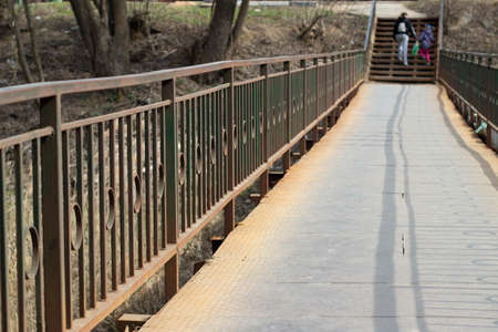 A bridge over the river. A pedestrian bridge over a body of water. It's a good place in the city.の写真素材