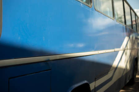 Blue bus. Public transport. Big car in the parking lot. Regular bus in summer.の写真素材