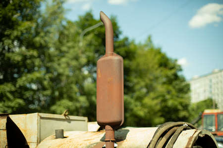 Rusty diesel engine pipe. Muffler on the engine. Rusty metal at the car part. Industrial equipment for electricity supply.の写真素材