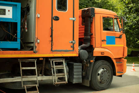 Special machine for servicing gas networks. Specialized transport with gas metering equipment. The work car is orange.の写真素材