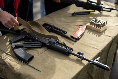 Firearm. Training in the possession of the machine. Lesson on the analysis of a firearm. A person learns to service automatic weapons.の写真素材