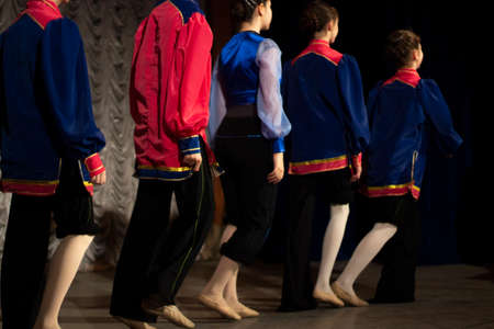 Children perform with dance on stage. Dance lessons. A lot of kids in the same clothes.の写真素材