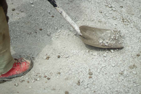 A shovel for construction. The shovel is a shovel with a long range. A worker throws rubble. Building material on a construction site.の写真素材