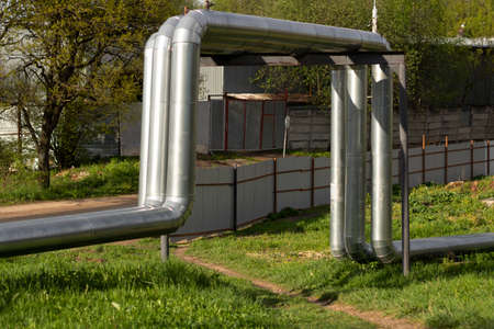Heating pipes on the surface. Hot water supply. The heating main is covered with stainless steel.の写真素材